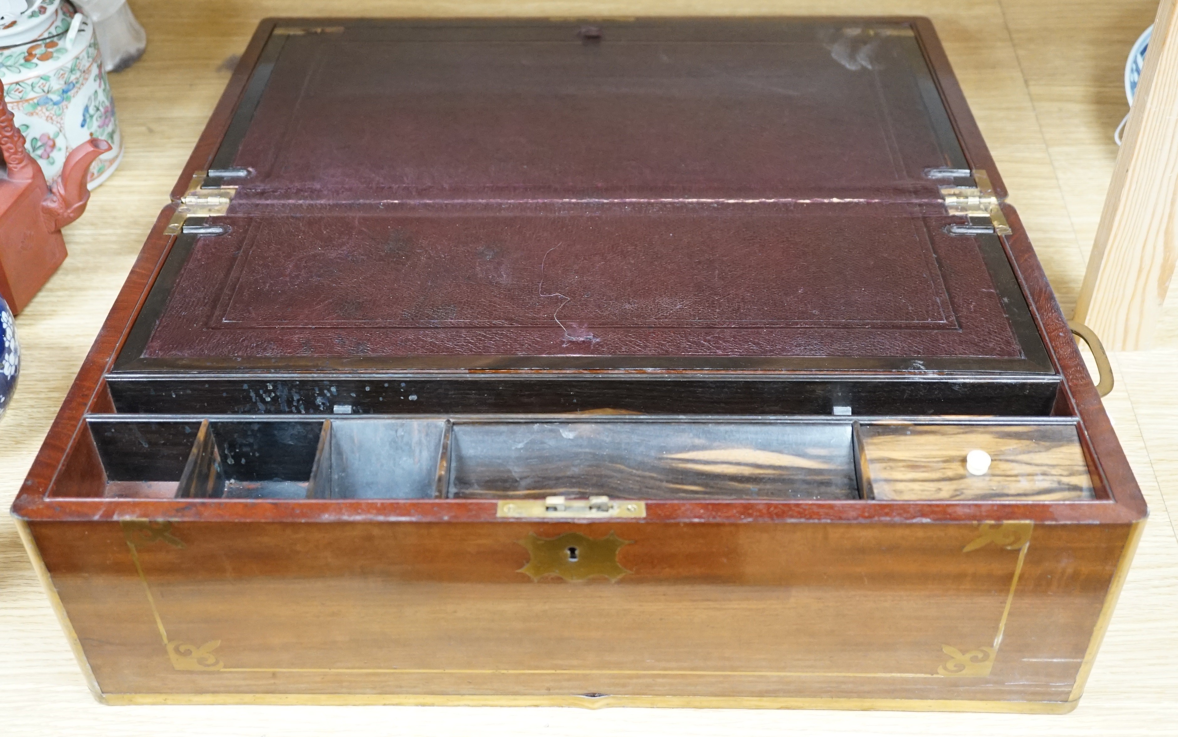 A brass inlaid mahogany writing slope, Coromandel covers to interior, 49cm wide